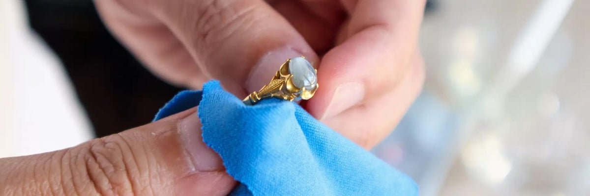 person wiping gold plated ring with cloth