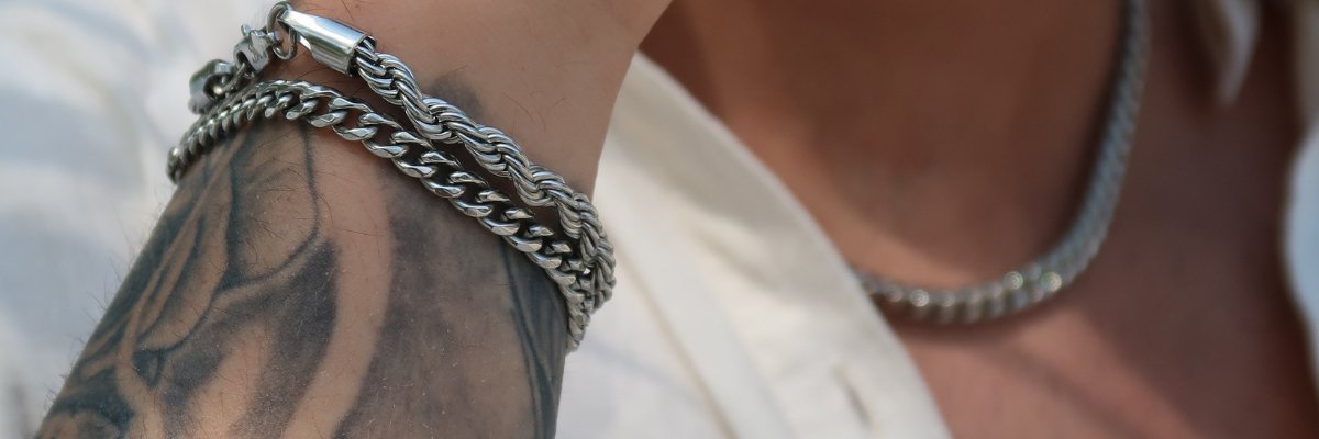 male wearing stainless steel bracelets and chain