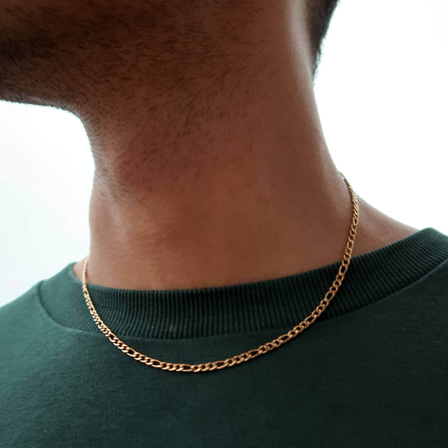 3mm gold figaro chain on male neck