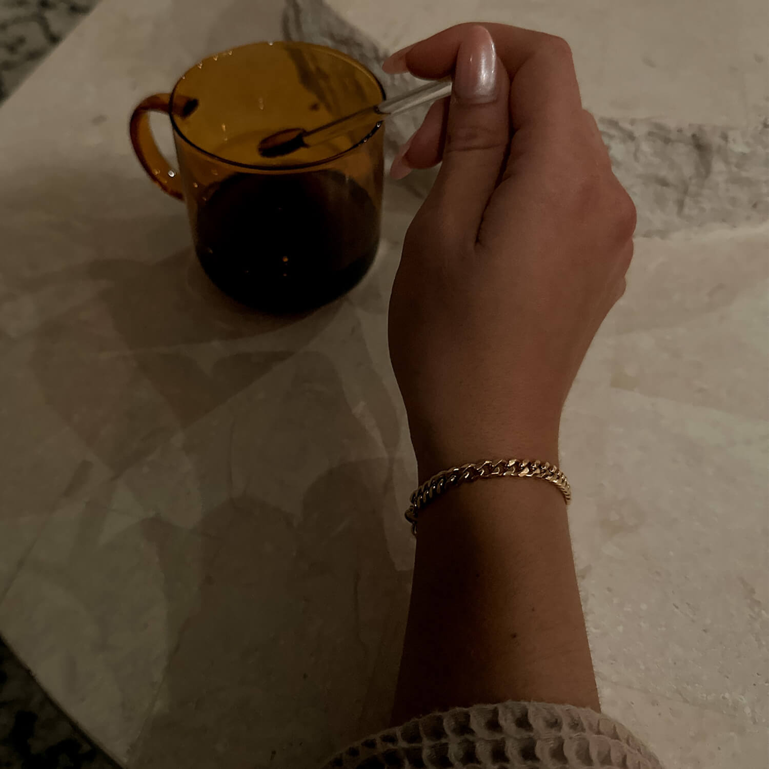 female wearing 5mm gold cuban link bracelet on wrist