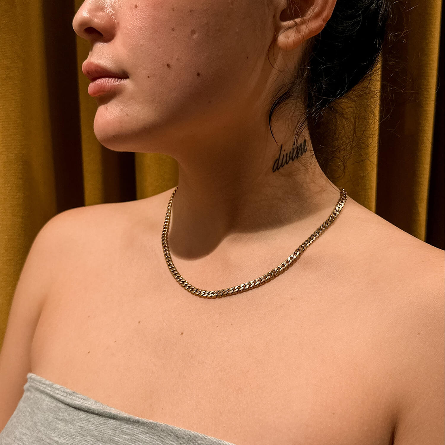 female wearing 5mm gold cuban link chain on neck