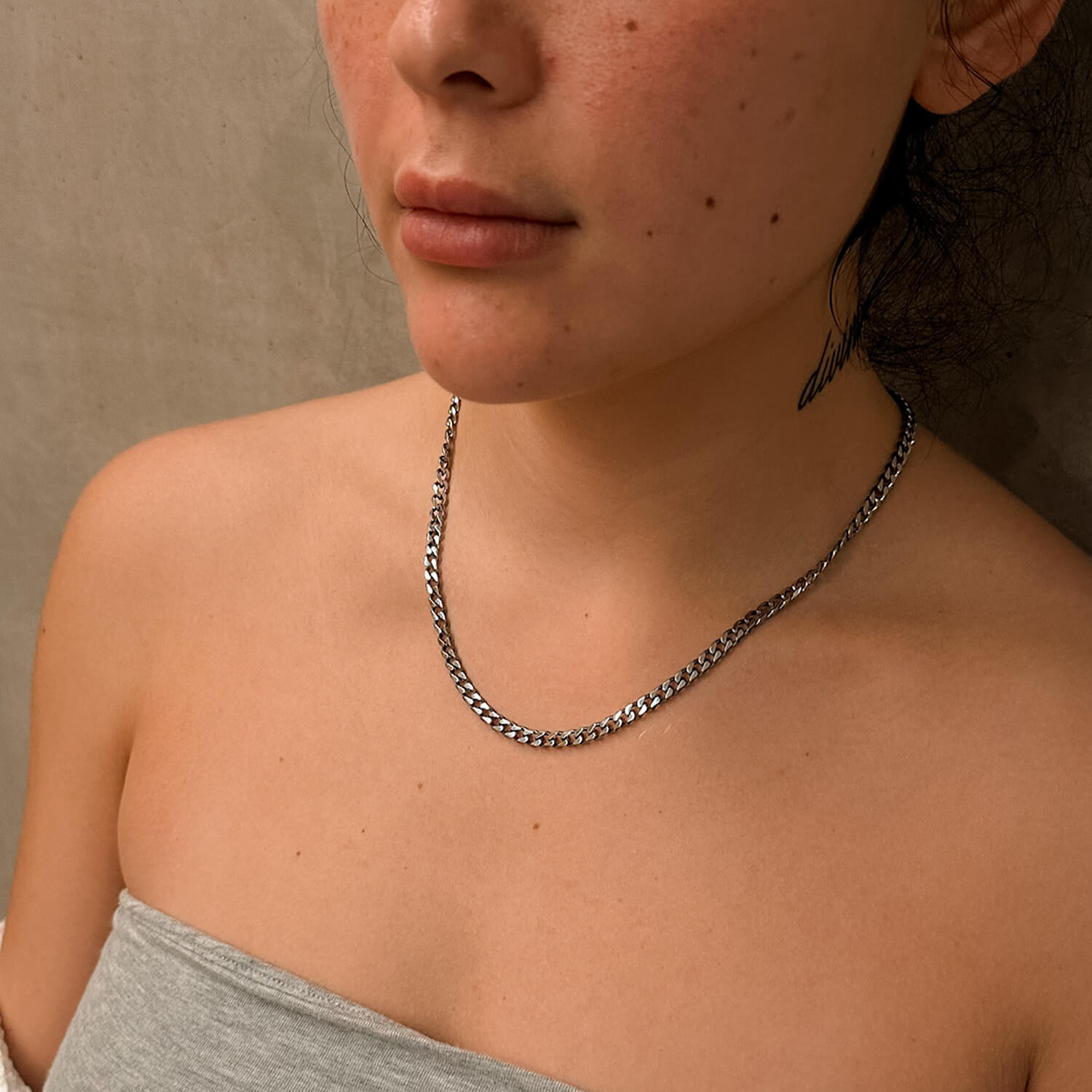 female wearing 5mm silver cuban link chain on neck