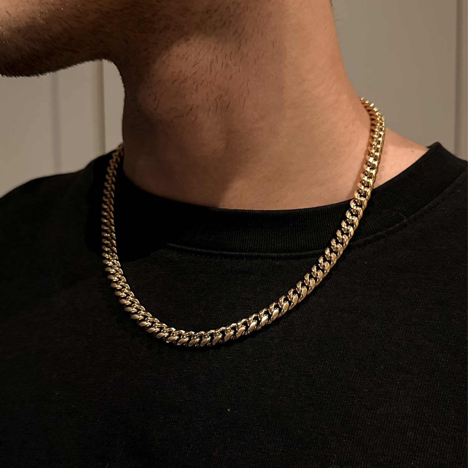 male wearing 8mm gold miami cuban link chain on neck