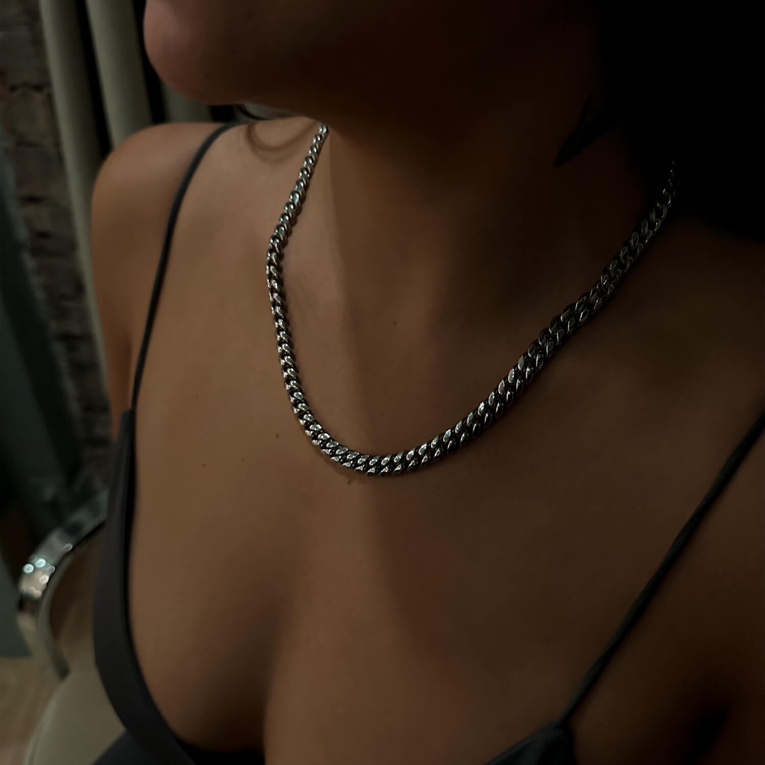 female wearing 8mm silver miami cuban link chain on neck