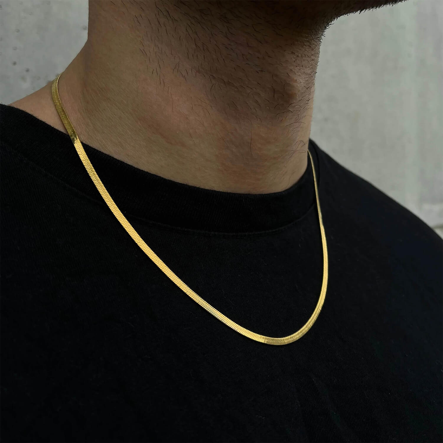 male wearing 3mm gold herringbone chain on neck