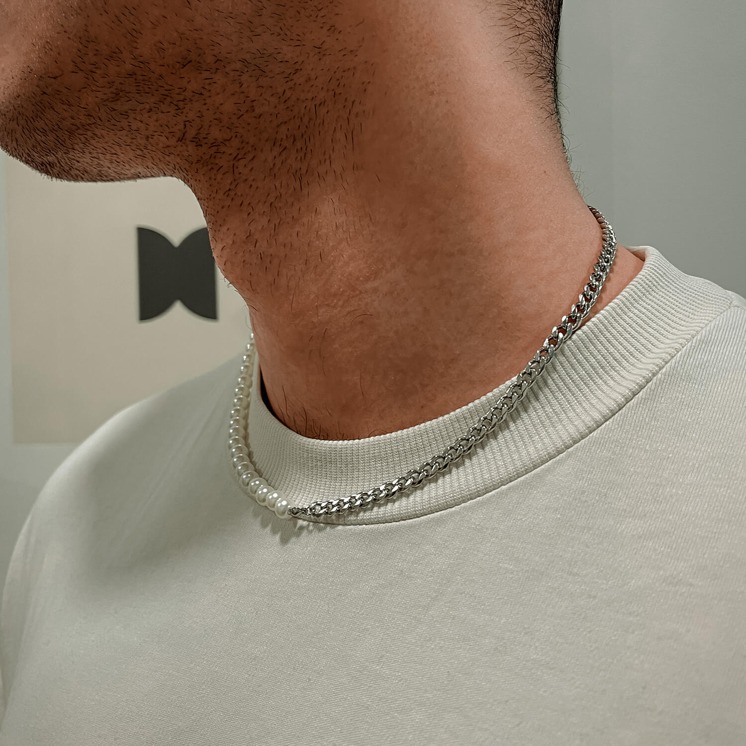 male wearing half pearl half cuban necklace