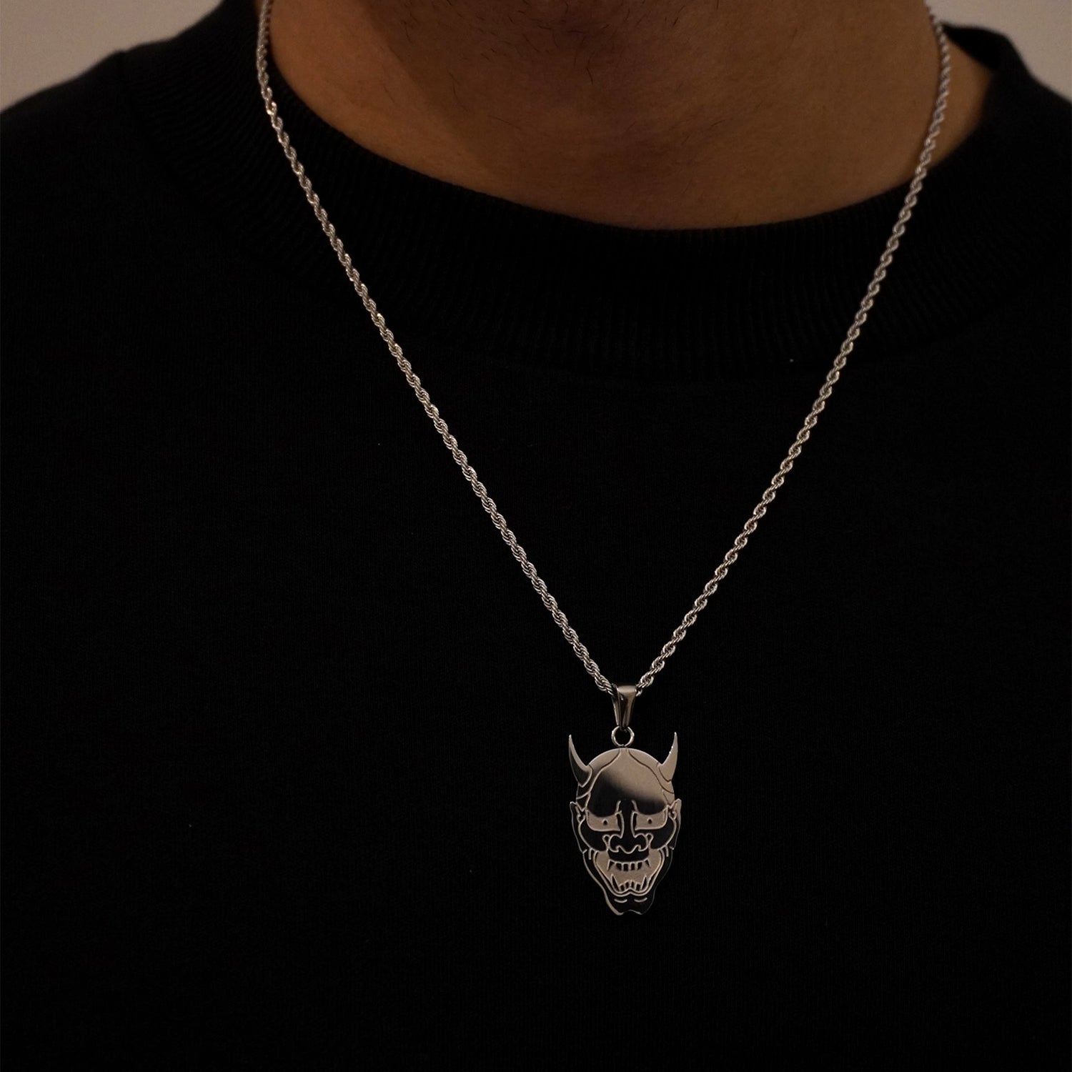 silver oni mask on neck